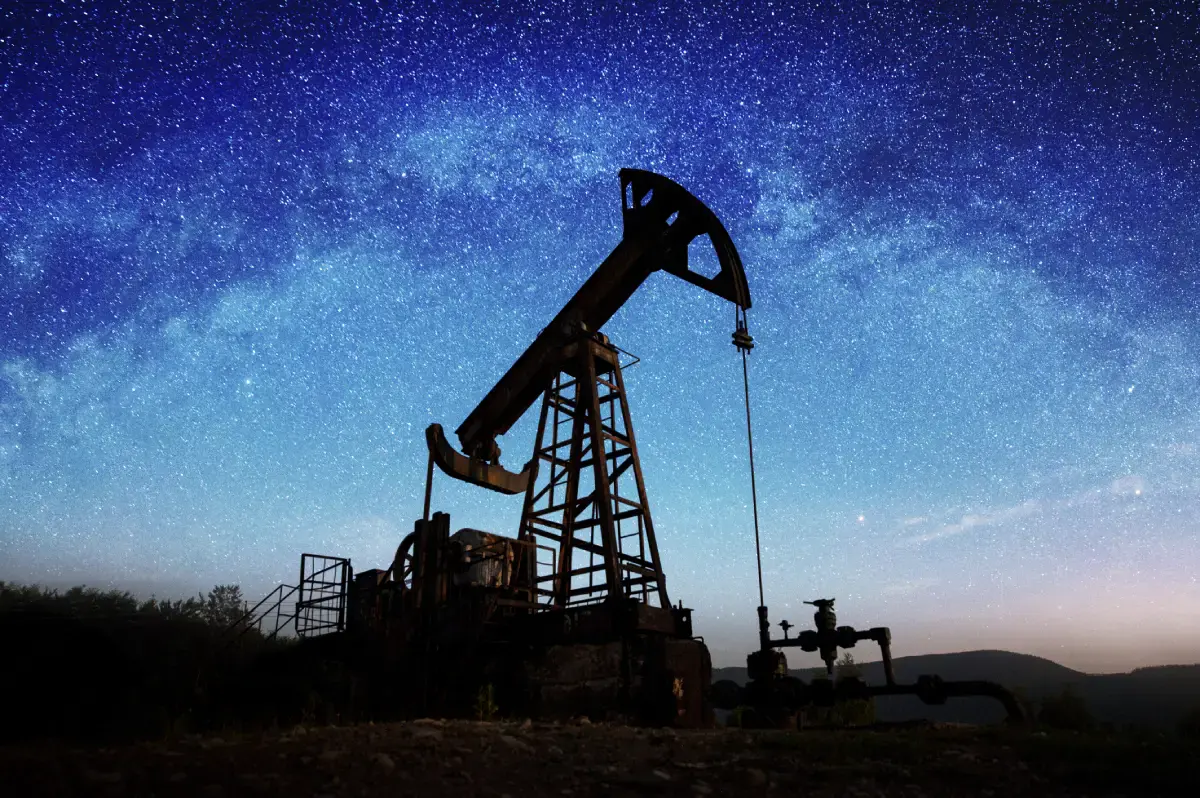 Oil pump jack under a starry sky